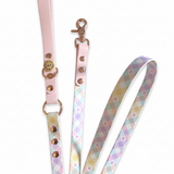 Dog leash with pink handle and patterned strap on a white background